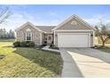 Inviting exterior featuring a two-car garage, manicured lawn, and a combination of brick and siding at 481 Autumn Springs Ct, Avon, IN 46123