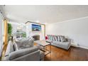 Bright living room featuring a white brick fireplace and hardwood floors, perfect for entertaining guests at 5108 Chatham Pl, Indianapolis, IN 46226