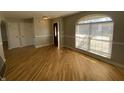 Inviting living room area with hardwood floors, large window, and stylish archway at 518 Waterford Way, Danville, IN 46122