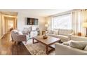 Spacious living room with hardwood floors, large window, comfortable seating, and stylish furnishings at 518 Wedgewood Dr, Anderson, IN 46013