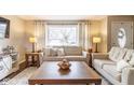 Inviting living room featuring neutral paint, hardwood floors, comfortable seating, and a large window at 518 Wedgewood Dr, Anderson, IN 46013