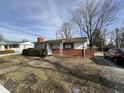 Quaint single-story home with brick accents, set on a cozy lot; ready for renovation at 5207 N Sadlier Dr, Indianapolis, IN 46226