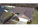 Aerial view of a well-maintained brick home, lush lawn, white fence, and outdoor play set at 7340 Oakview Dr, Avon, IN 46123