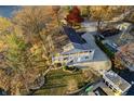 Aerial view of a home with a lakeside dock, sprawling lawn, and mature trees surrounding the residence at 7780 Paw Paw Dr, Nineveh, IN 46164