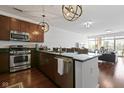 A modern kitchen features stainless steel appliances, granite countertops, and stylish pendant lighting at 802 N Meridian St # 204, Indianapolis, IN 46204