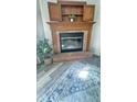 Cozy brick fireplace with wooden mantel, perfect for relaxing evenings, plus view of decor at 8271 Shattuck Dr, Avon, IN 46123
