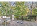 A wooden deck offers an ideal outdoor setting for relaxation, overlooking surrounding woods and nature at 8425 N Halyard N Way, Indianapolis, IN 46236