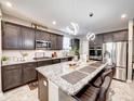 Modern kitchen featuring a large island, stainless steel appliances, and stylish lighting at 8729 Dorill Creek Ln, Indianapolis, IN 46259