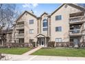 Inviting exterior view of a multi-story condo building with balconies, well-maintained landscaping, and clearly marked address at 8820 Yardley Ct # 101, Indianapolis, IN 46268