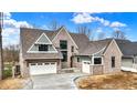 Beautiful brick two-story home with attached garage and manicured landscaping, perfect for Gathering living at 908 Oak Terrace Rd, Westfield, IN 46074