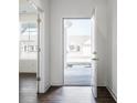 Bright entryway with hardwood floors, a view of the home across the street, and a nearby room at 9839 Canyon Ln, Pendleton, IN 46064