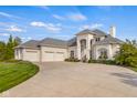 Charming white brick home boasting a three-car garage, a well-manicured lawn, and tasteful landscaping at 995 Westlake Hills Dr, Columbus, IN 47201