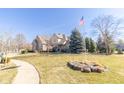 Spacious home with well-manicured lawn and landscaping, accented by an American flag at 1115 Morningside Ct, Greenfield, IN 46140