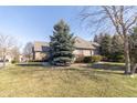 Attractive single-story home with brick exterior, mature trees, and neatly trimmed bushes at 1115 Morningside Ct, Greenfield, IN 46140