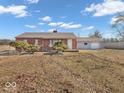 Charming single-story brick home with a manicured lawn and attached garage at 1229 N German Church Rd, Indianapolis, IN 46229