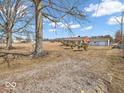 The yard is expansive, with mature trees enhancing its depth and character at 1229 N German Church Rd, Indianapolis, IN 46229