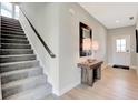 Inviting entryway with staircase, light wood floors, and stylish decor at 1240 Taggart Way, Greenwood, IN 46143