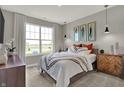 Comfortable main bedroom with a large window offering ample natural light and neutral decor at 1249 Sika Ln, Greenwood, IN 46143