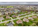 Wide aerial view of a neighborhood highlighting many homes, streets, and community spaces at 12526 Pembrooke Cir, Carmel, IN 46032