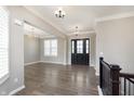 Open foyer with hardwood floors and elegant chandelier lighting at 1499 Avondale Dr, Westfield, IN 46074
