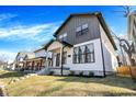 Street view of a stylish two-story home with a covered porch, showcasing its modern architecture and curb appeal at 1603 Nowland Ave, Indianapolis, IN 46201