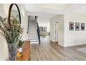 Inviting foyer with wood floors, a staircase, and views of the living room and natural light at 1603 Nowland Ave, Indianapolis, IN 46201