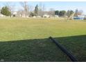 Expansive backyard with a level lawn, perfect for outdoor activities, framed by mature trees at 210 Evergreen St, Morgantown, IN 46160