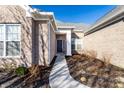Close-up of a home's entry with a manicured garden, a walkway leading to the front door at 2352 Somerset Cir, Franklin, IN 46131
