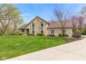 Beautiful stone-faced home with lush green lawn, mature landscaping, and a welcoming driveway at 241 Melissa Ann Ct, Indianapolis, IN 46234
