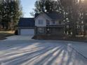 Inviting two-story home with a well-manicured lawn, brick details, and an attached two-car garage at 293 Spruce Ct, Martinsville, IN 46151