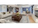 Open-concept living room with hardwood floors, fireplace, and views to the kitchen and dining area at 30 W Main St # 3D, Carmel, IN 46032