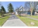 Charming two-story home with an American flag displayed, inviting front porch and long driveway at 302 S Sherman Dr, Indianapolis, IN 46201