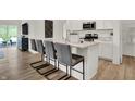 Modern kitchen featuring a center island with bar seating, stainless steel appliances, and sleek white cabinetry at 3769 Cantebury Dr, Franklin, IN 46131