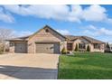 Lovely brick home with a spacious driveway, three-car garage, and beautifully landscaped front yard at 397 Linden Ridge Trl, Greenwood, IN 46142