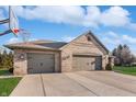 View of the brick home's spacious three-car garage with a basketball hoop at 397 Linden Ridge Trl, Greenwood, IN 46142