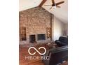 Cozy living room featuring a brick fireplace, hardwood floors, and a beamed ceiling at 4031 N Banta Rd, Bargersville, IN 46106