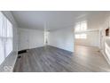 Spacious and airy living room with laminate floors and neutral color palette at 4132 Richelieu Rd, Indianapolis, IN 46226