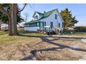 Two-story home with green roof and inviting deck, complemented by mature trees and ample outdoor space at 4254 N 200 W, Greenfield, IN 46140