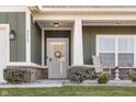 Charming home featuring an inviting front porch, brick accents, and beautifully landscaped front yard at 4313 W Hidden Preserve Cv, New Palestine, IN 46163
