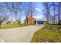 Lovely brick home with an attached garage and well-maintained yard at 449 Old Hickory Ln, Greenwood, IN 46142