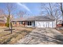 Charming single-story home featuring a two-car garage, brick accents, and well-maintained front yard at 614 Sunblest S Blvd, Fishers, IN 46038