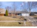 Charming single-story home featuring a two-car garage, brick accents, and well-maintained front yard at 614 Sunblest S Blvd, Fishers, IN 46038