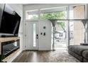 Bright living area featuring hardwood floors, electric fireplace, and multiple windows that flood the space with natural light at 632 N Temple Ave, Indianapolis, IN 46201