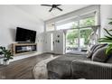 Inviting living space with a plush corduroy couch, electric fireplace, and large windows offering neighborhood views at 632 N Temple Ave, Indianapolis, IN 46201