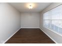 Bright room with hardwood floors, neutral walls, and natural light streaming through a window at 6513 Kingsbury Way, Zionsville, IN 46077