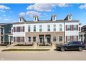 Inviting townhome exterior featuring stone accents and a parked black BMW sedan at 656 Lagerfield Dr, Carmel, IN 46032