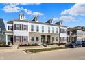 Well-maintained townhomes with stone accents, dormer windows, and manicured front lawns at 656 Lagerfield Dr, Carmel, IN 46032