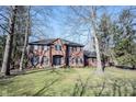 Stately two-story brick home featuring a well-manicured lawn and symmetrical design at 8220 Traders Hollow Ct, Indianapolis, IN 46278