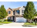 Attractive two-story home with well-kept lawn, features brick and vinyl siding, and mature trees at 948 Northwich Ave, Westfield, IN 46074