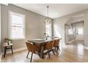 Bright dining room with hardwood floors, modern light fixture, and large windows at 1041 S State Ave, Indianapolis, IN 46203